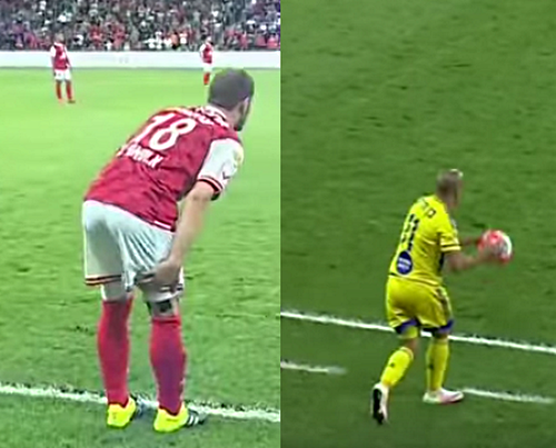 Bnei Sakhnin player holds hurt thigh and Maccabi TA player continues soccer game