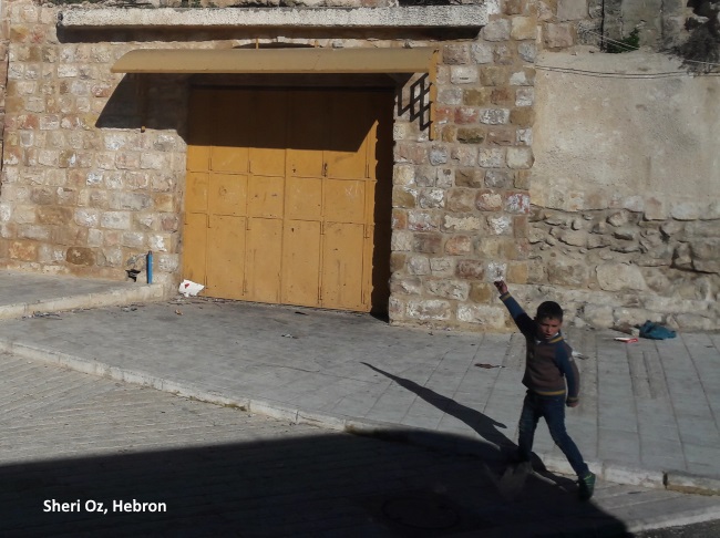 kid throwing stones in Hebron