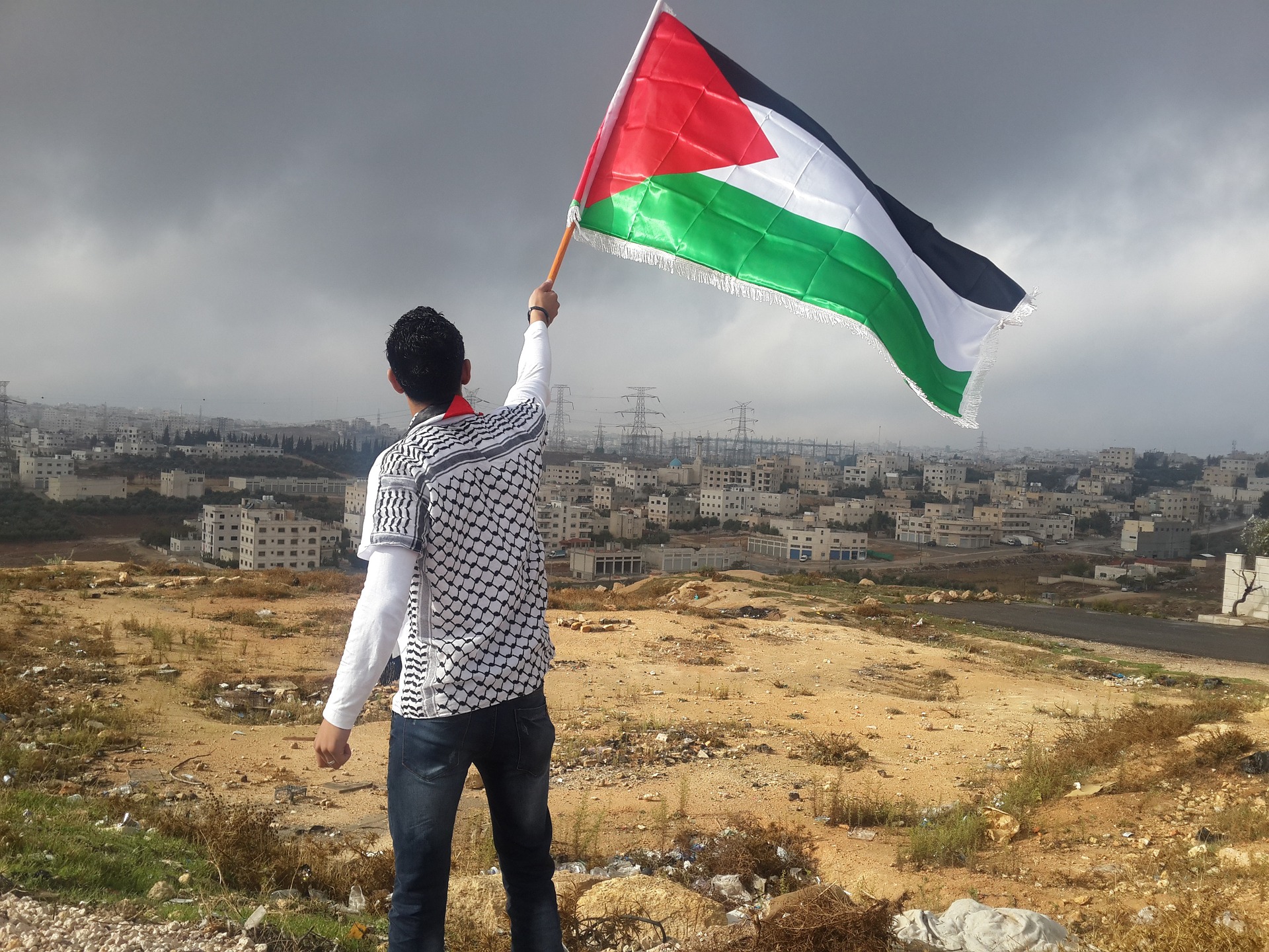 Palestinian identity - holding a Palestinian flag aloft