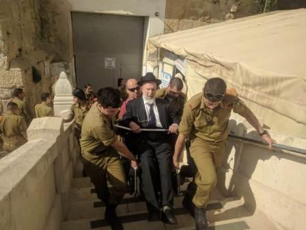 being carried up the stairs at the Cave of the Patriarchs