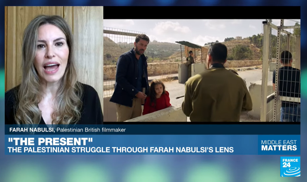 soldier cocks rifle and points in direction of Yusef and his daughter