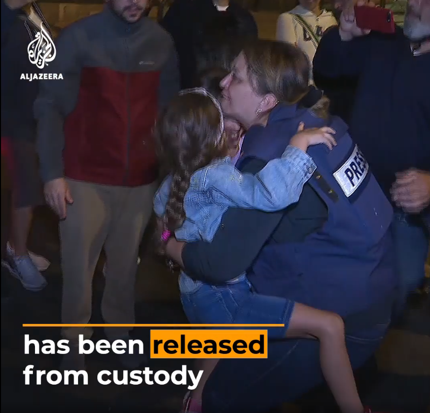 Givara Albudeiri photo from video of her release on Al-Jazeera showing holding child with "broken" arm