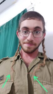 Ariel shows off the pink ends of his sidelocks.