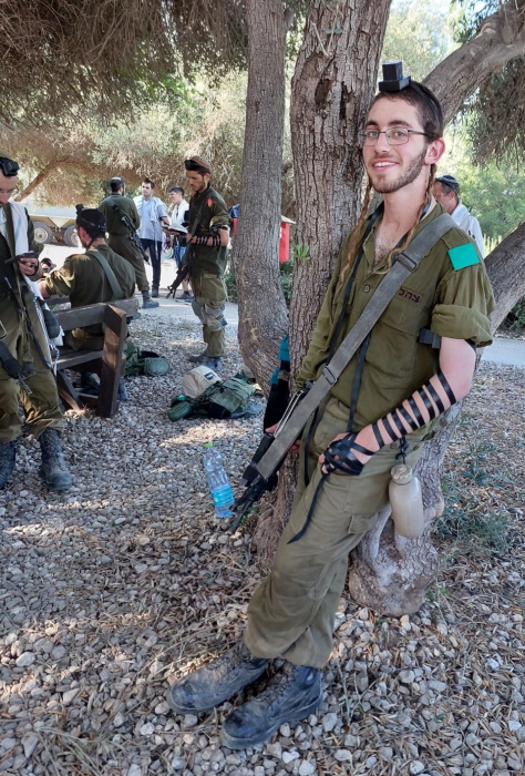 Ariel praying the morning prayer after the military trek that ends his basic training